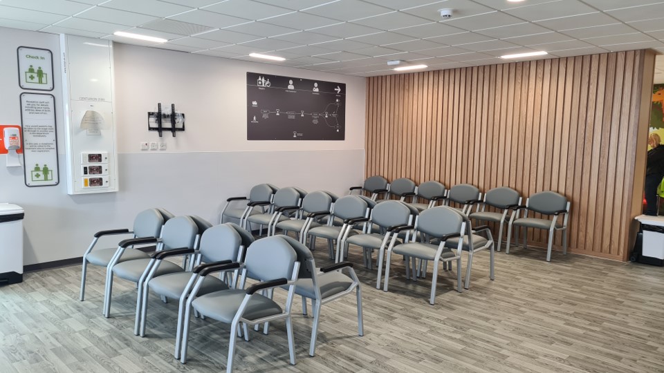 The new Grimsby Emergency Department waiting area, featuring pale wooden panelling and a number of grey chairs