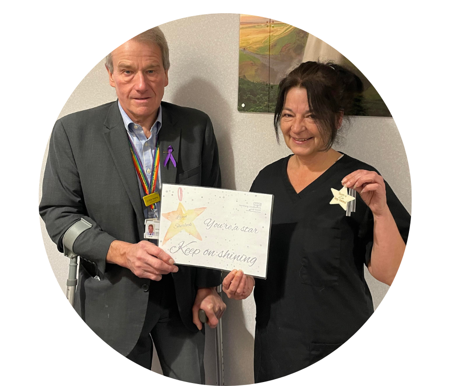 Stars of 2022: Scunthorpe Mortuary Assistant Lynn Sherlock receiving her award from Chief Executive Peter Reading