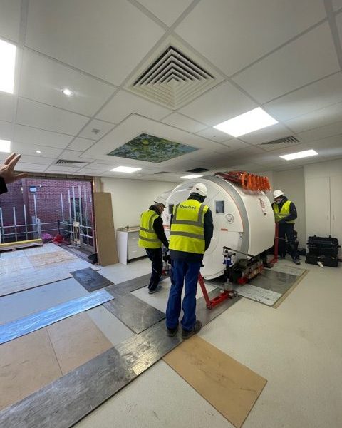 Contractors putting the new MRI scanner into place