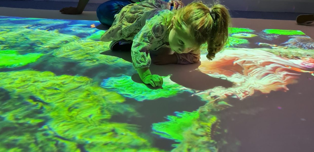 A girl using an interactive floor.