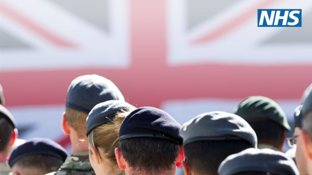 The NHS logo sits atop the Union Flag, as Armed Forces personnel look on