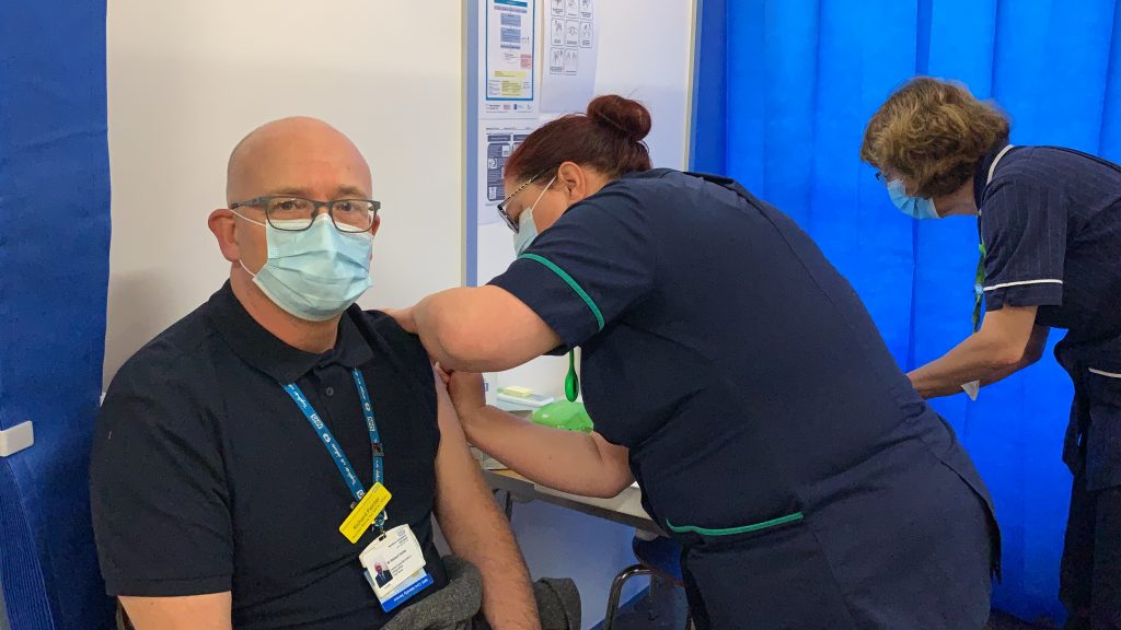 Richard receiving the COVID-19 vaccine