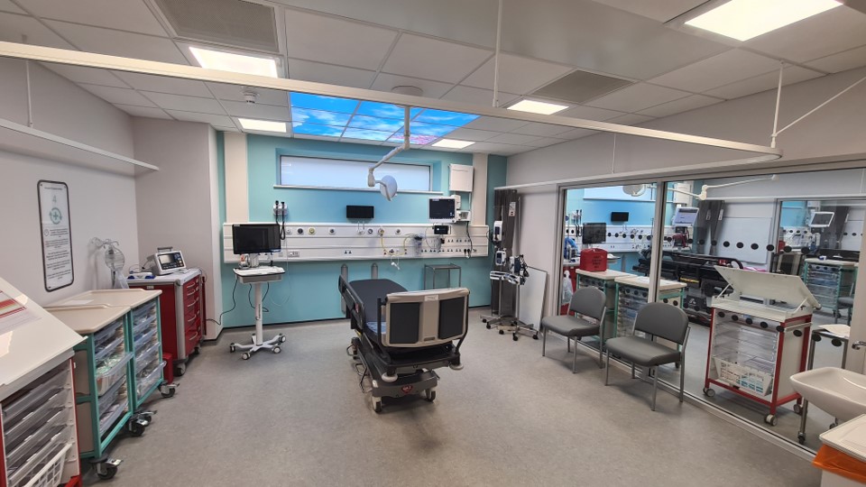 A resuscitation bay in the new Grimsby Emergency Department.
The walls are glass to enable patients to be easily monitored and lit panels above the bed are designed to look like a blue sky.