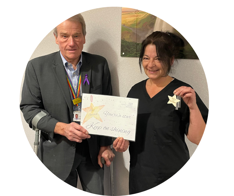 Stars of 2022: Scunthorpe Mortuary Assistant Lynn Sherlock receiving her award from Chief Executive Peter Reading