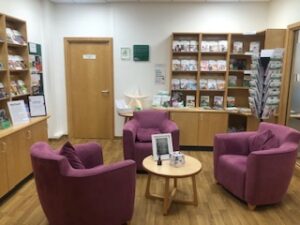 three purple chairs in a room with leaflets