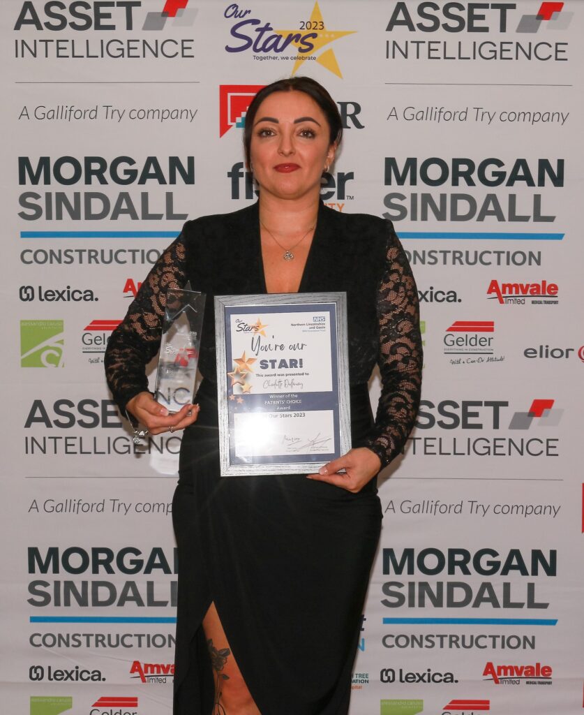 a woman holds a trophy and certificate