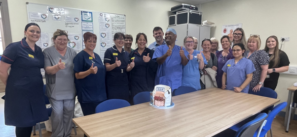 a group of staff in uniform giving the thumbs up