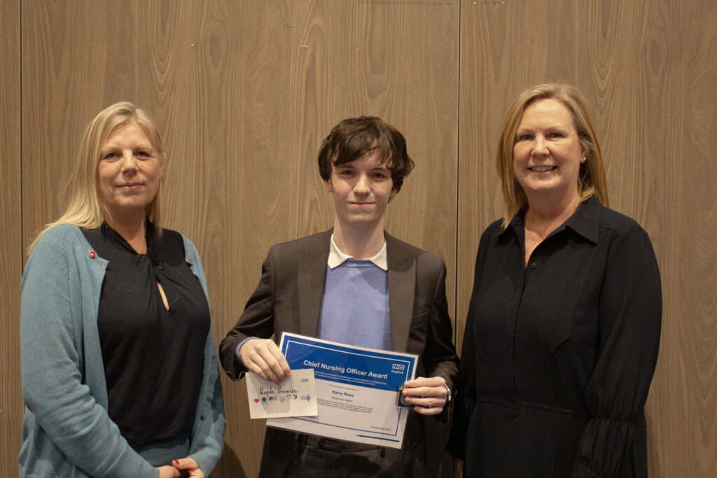Harry Ross, centre, holds his certificate with Victoria Bagshaw to his right and Jenny Hinchliffe, Site Nurse Director, to his right