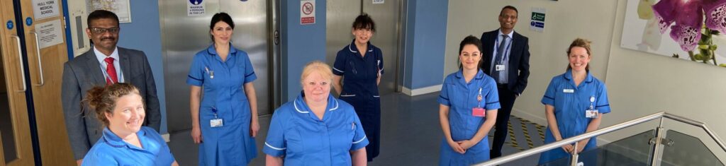 a group of clinical staff stood on a stairwell