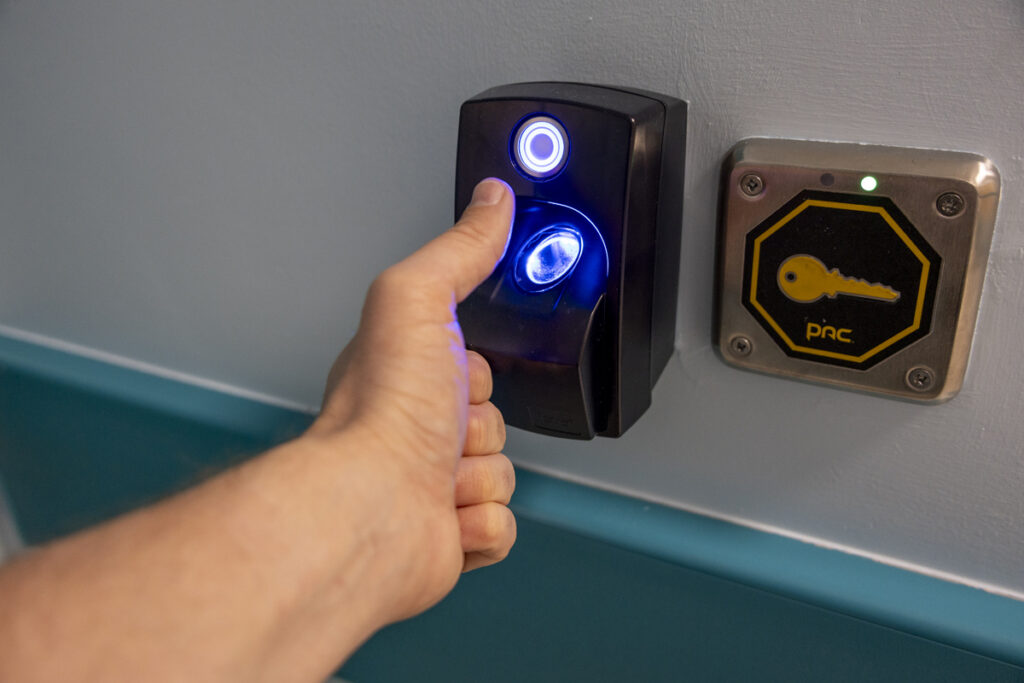 A hand about to scan the fingerprint outside the door of the NICU