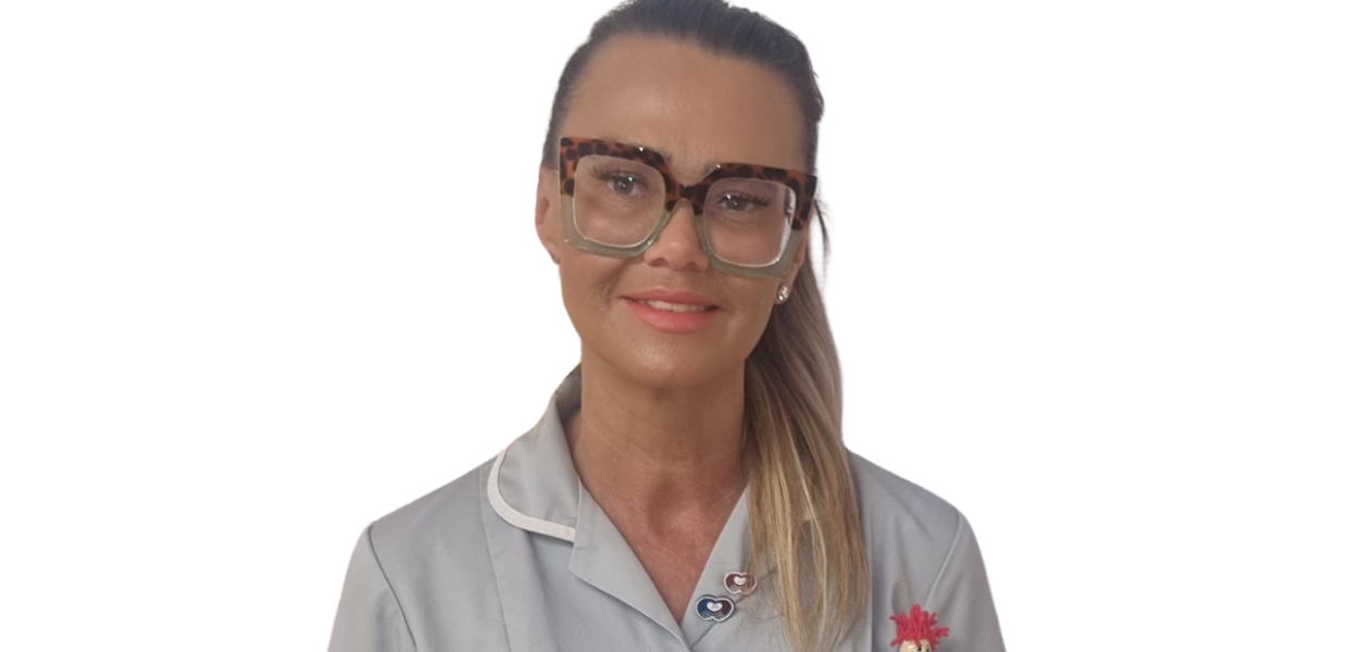 A woman is wearing a a grey healthcare uniform