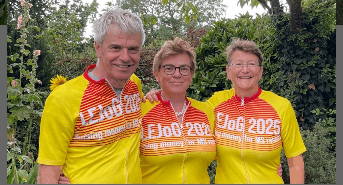 Adrian, Jacquie and Sarah in their cycling tops, arm in arm