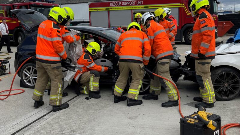 firefighters around a car wreck