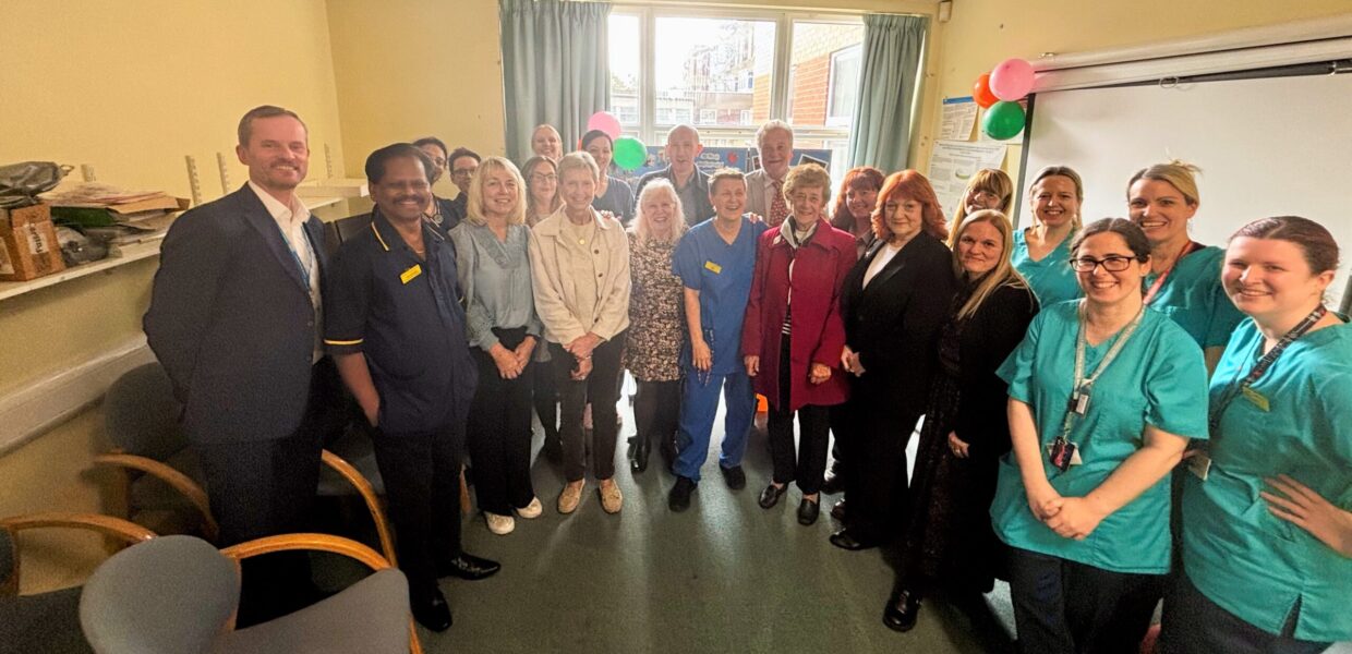 a group of staff stood in a semi curcle