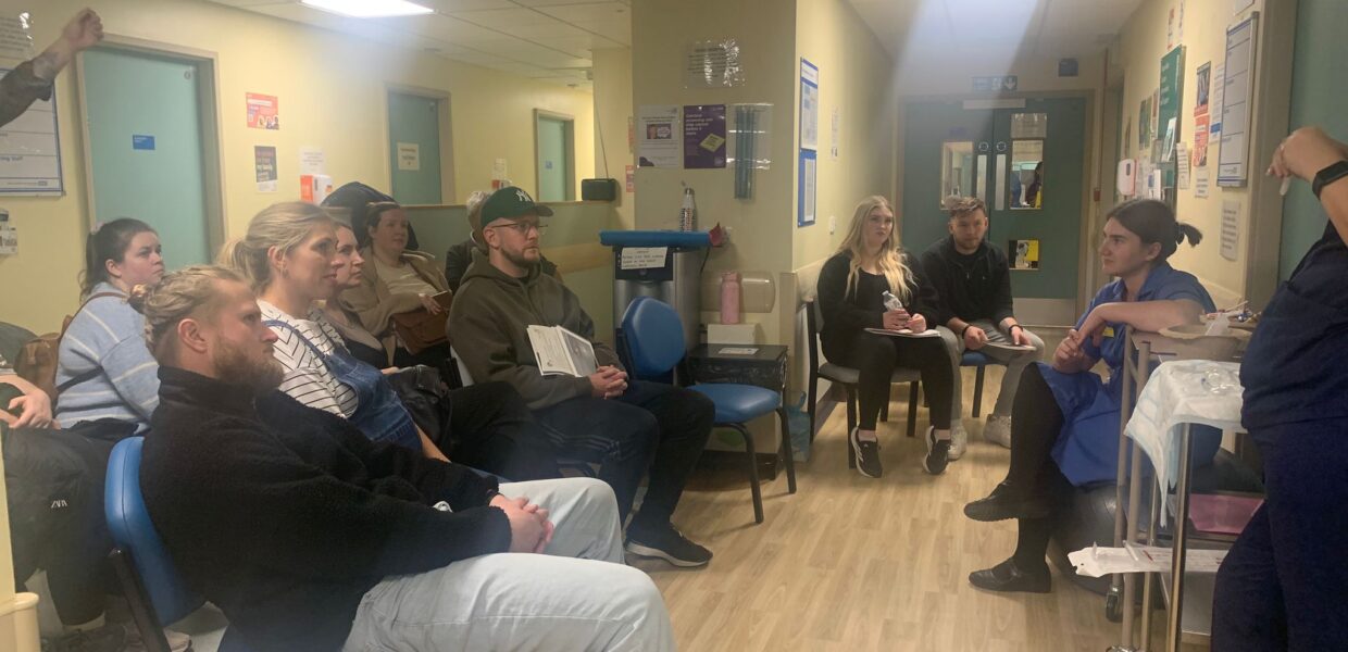 Couples listening to a midwifery talk at the Nest and Nurture event