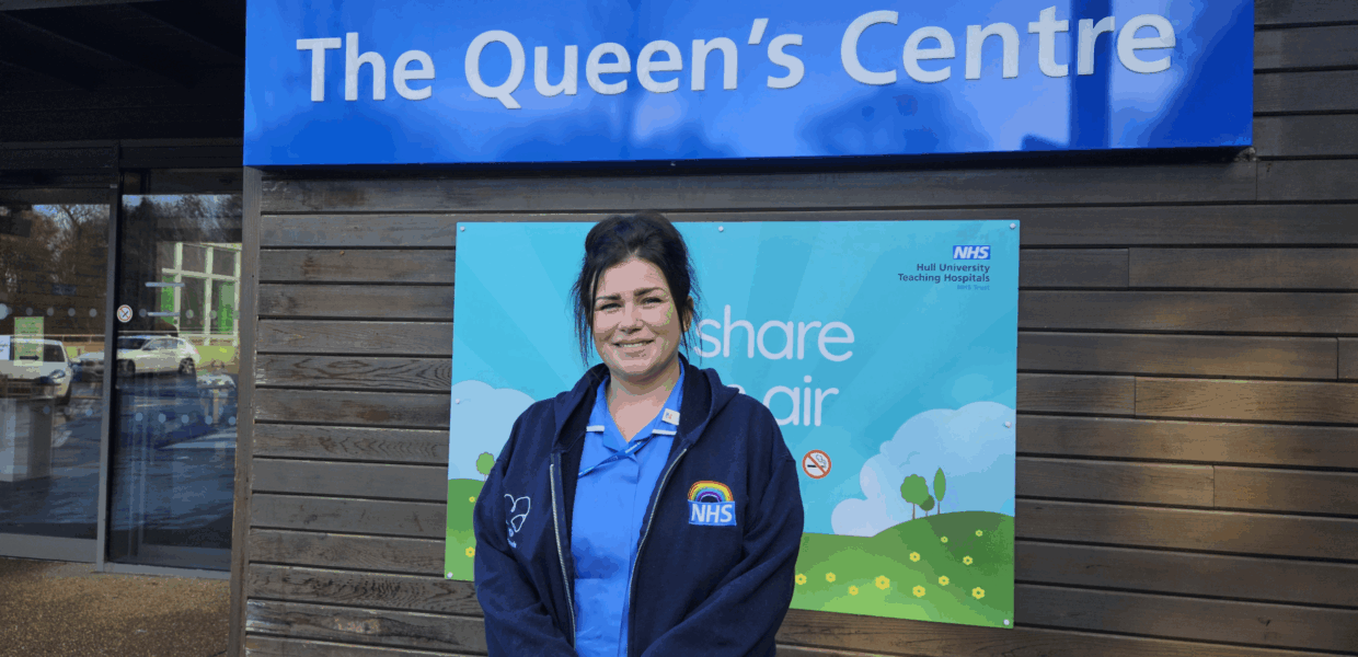 Zowie Fussey in nursing uniform standing outside the Queen's Centre