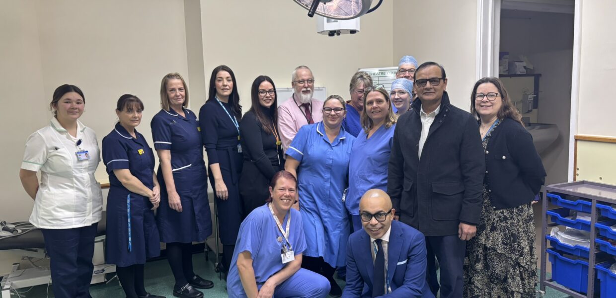 A group of NHS staff in a theatre room