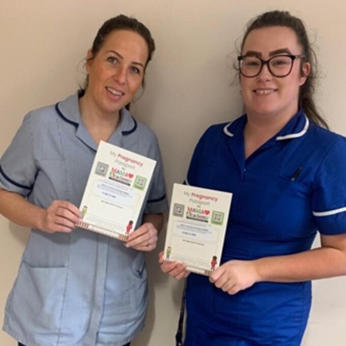 Maternity Support Worker Katie Saunby stands on the left beside Midwife Samantha Brotherton. Both are holding the MAMA Academy Pregnancy Passports that will be handed out from this week