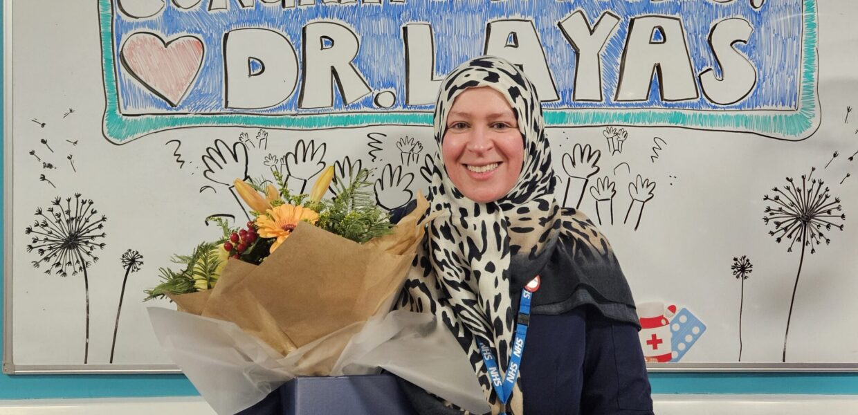 A woman stood holding flowers