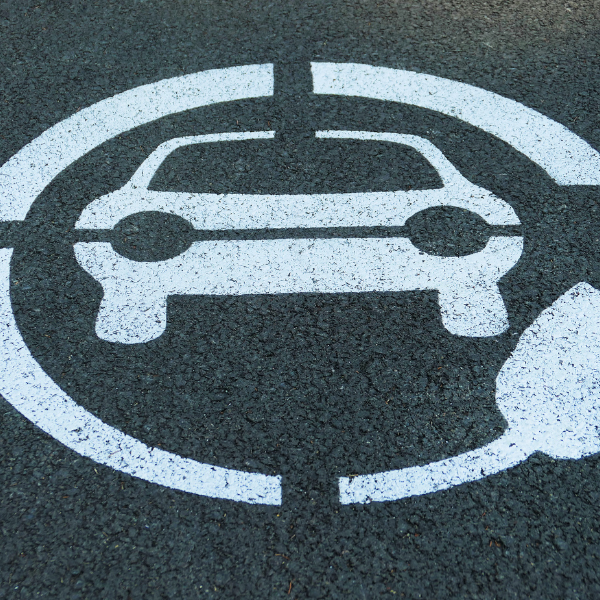 An EV charging symbol painted onto a parking area