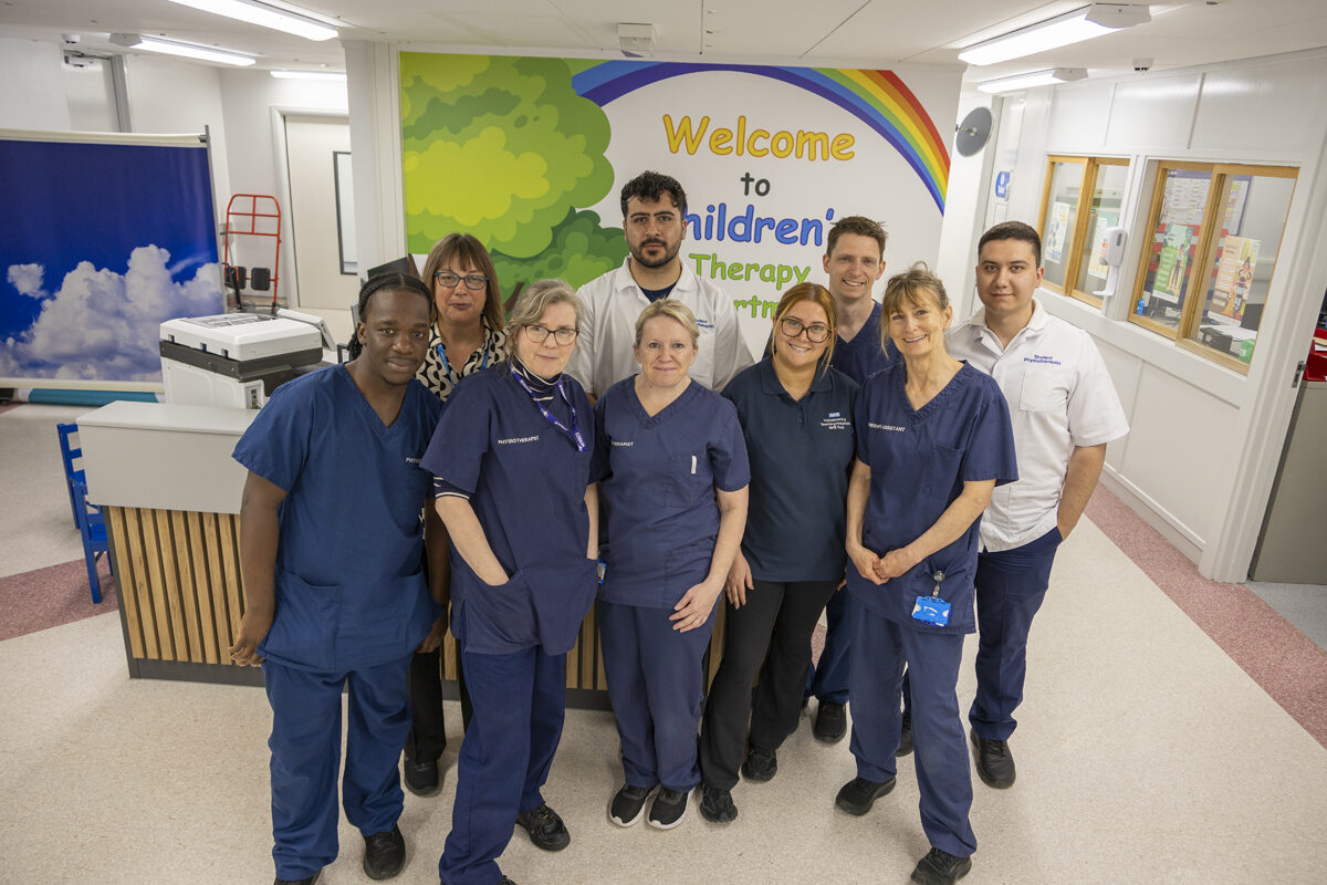 Hospital staff standing in a group at the therapies reception desk