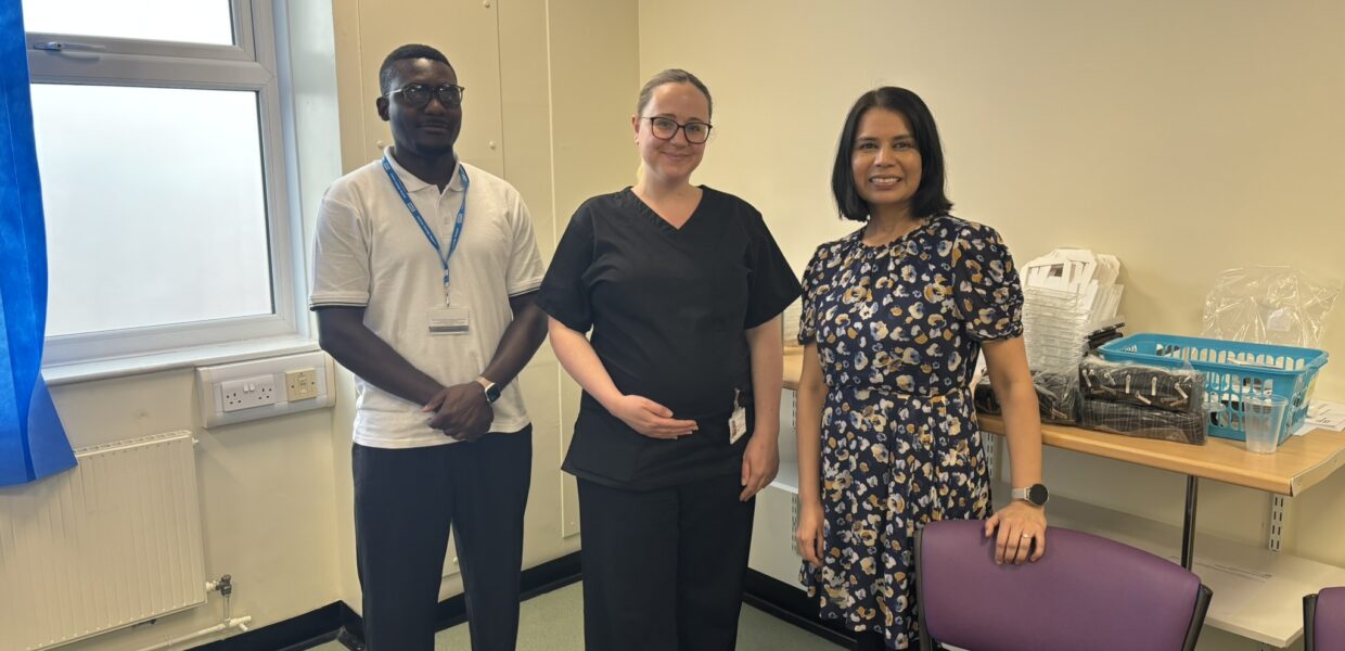 A group of NHS staff in a hospital clinic room