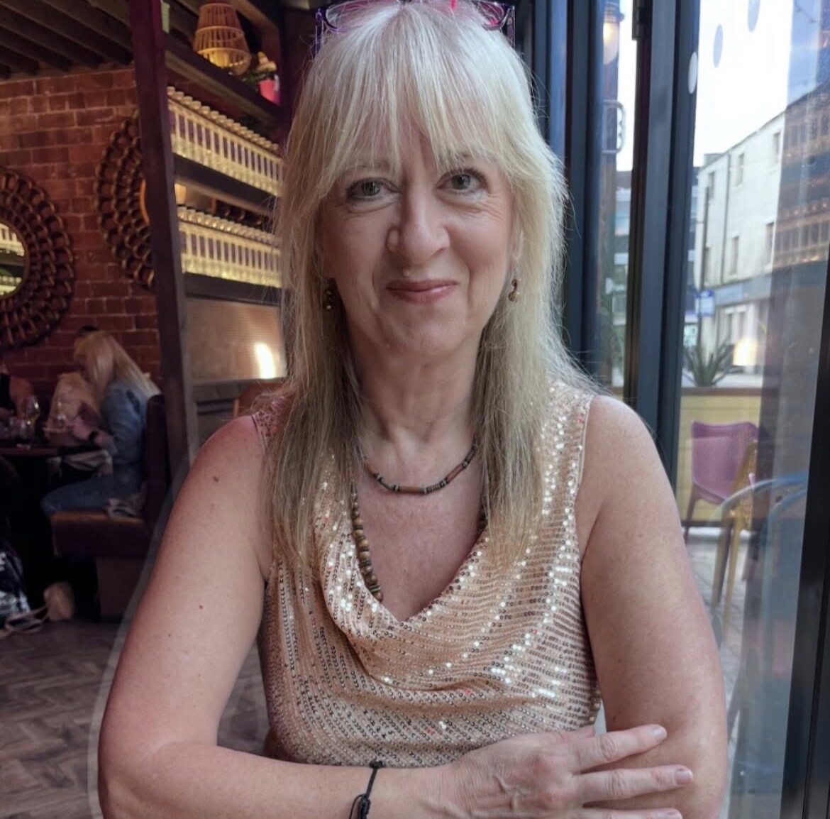 Pauline Thornton sitting in a restaurant, smiling at the camera