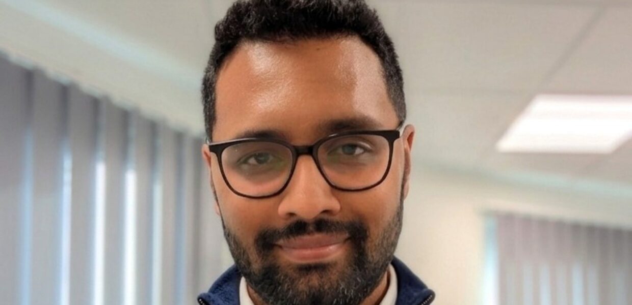 A man wearing glasses smiling