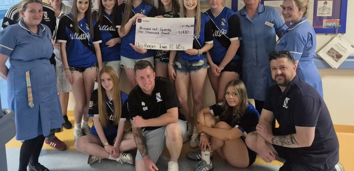 Clee Town Girls U15s present their donation to the DPoW NICU team