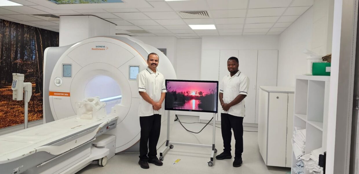 (Left to right): Mallikarjun Kattemane, Senior II Radiographer, and Chikezie Ani, CT/MRI Radiographer, pictured with the system.