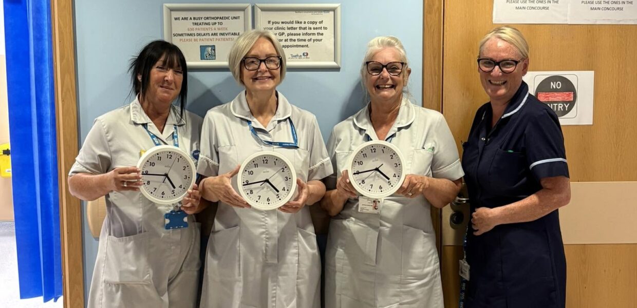 Nurses on a ward holding clocks
