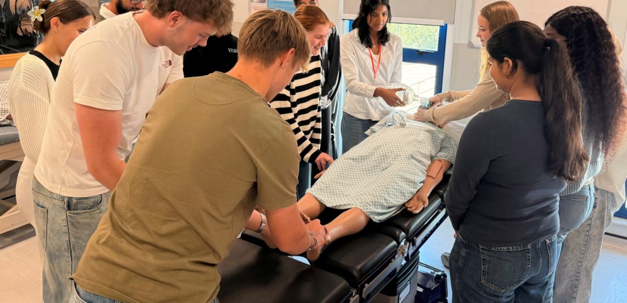 A group of students practising on a manikin