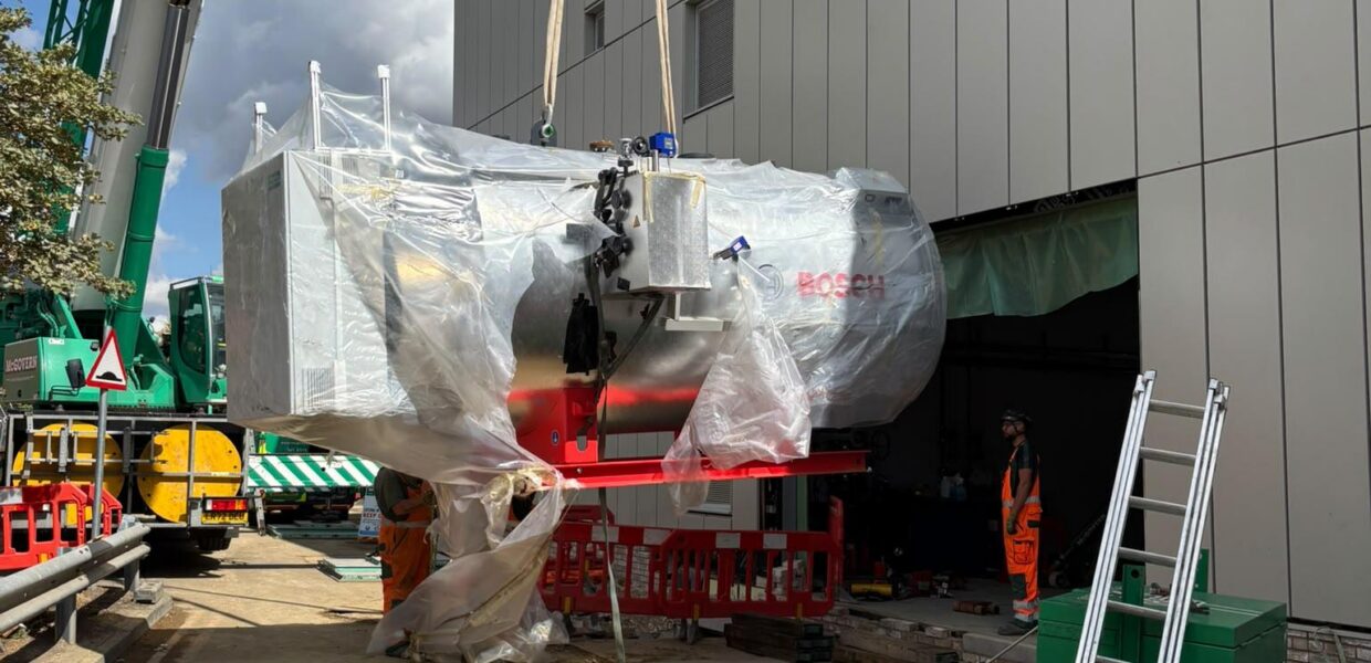 The electric boiler being craned into position
