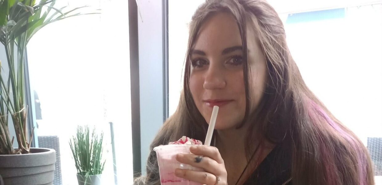 A woman holding a drink