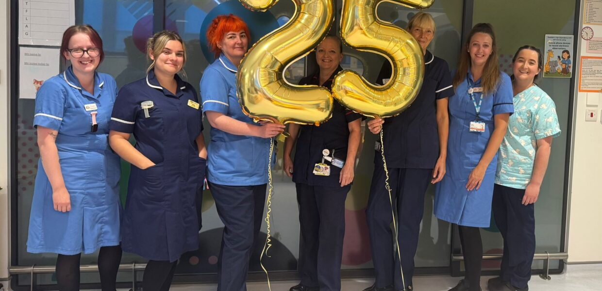 PHDU staff holding '25' balloons