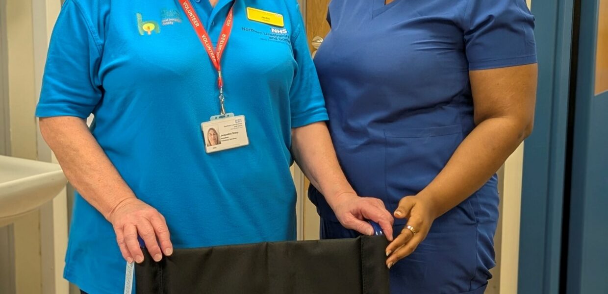 Jackie (left) handing over the wheelchair