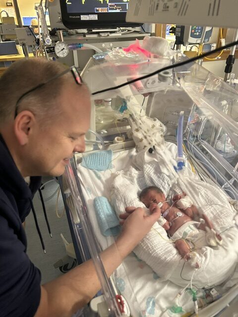 Little Theodore is in an incubator, looked over by his dad, Dave