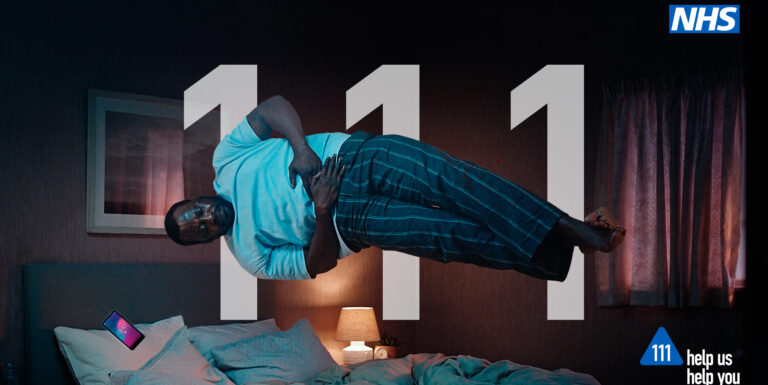 A man clutching his stomach. NHS 111 Help us Help you