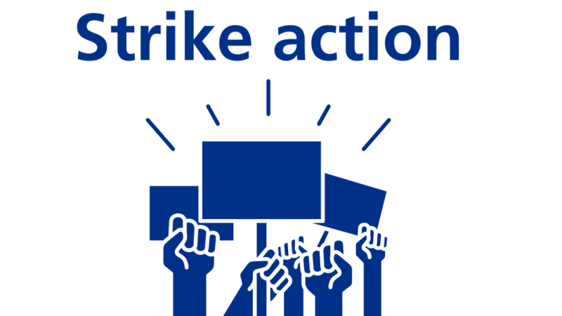 Hands holding placards with the words strike action