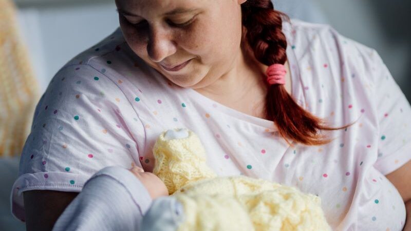 a new mum holds her baby