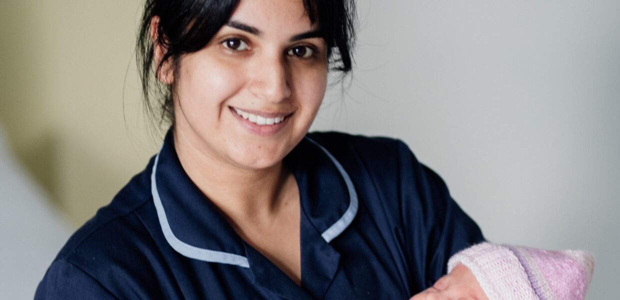 A midwife holding a baby