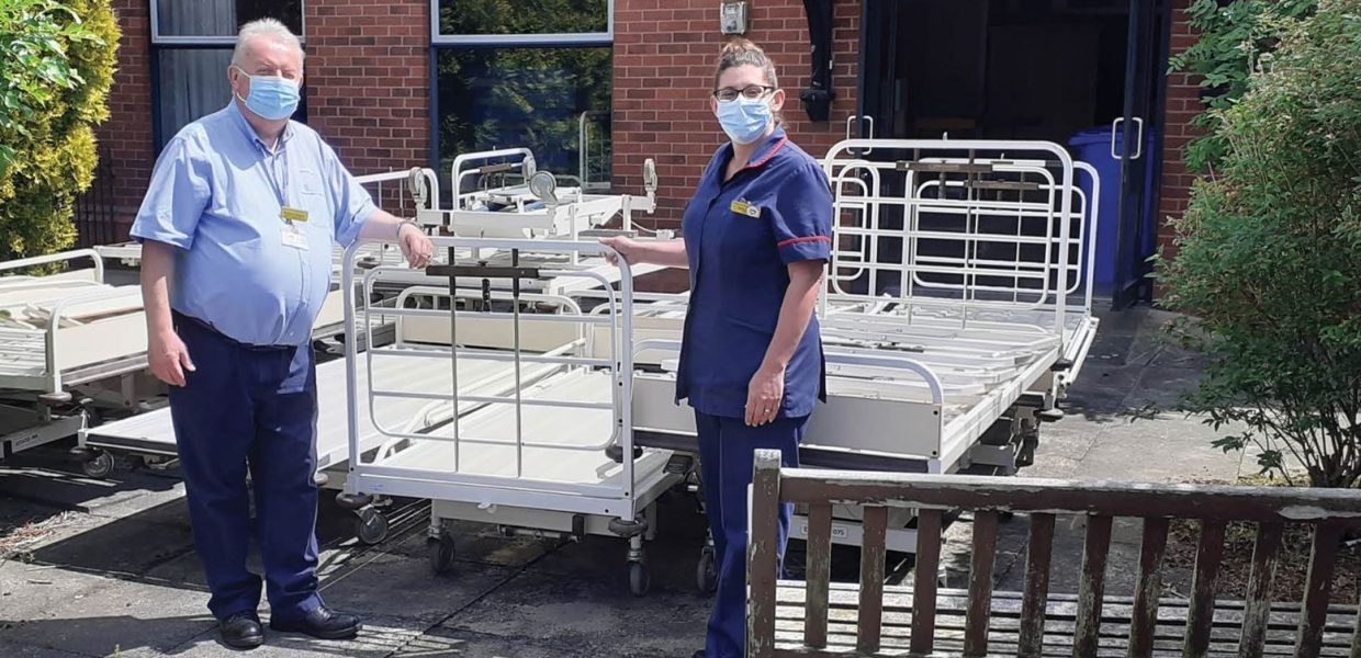 Our staff pose with hospital beds being donated to Third World Countries