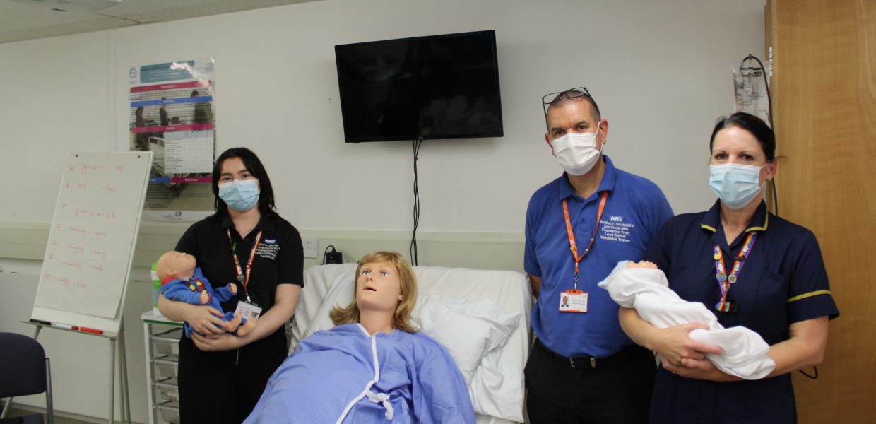 The clinical simulation team with one of the state-of-the-art manikins