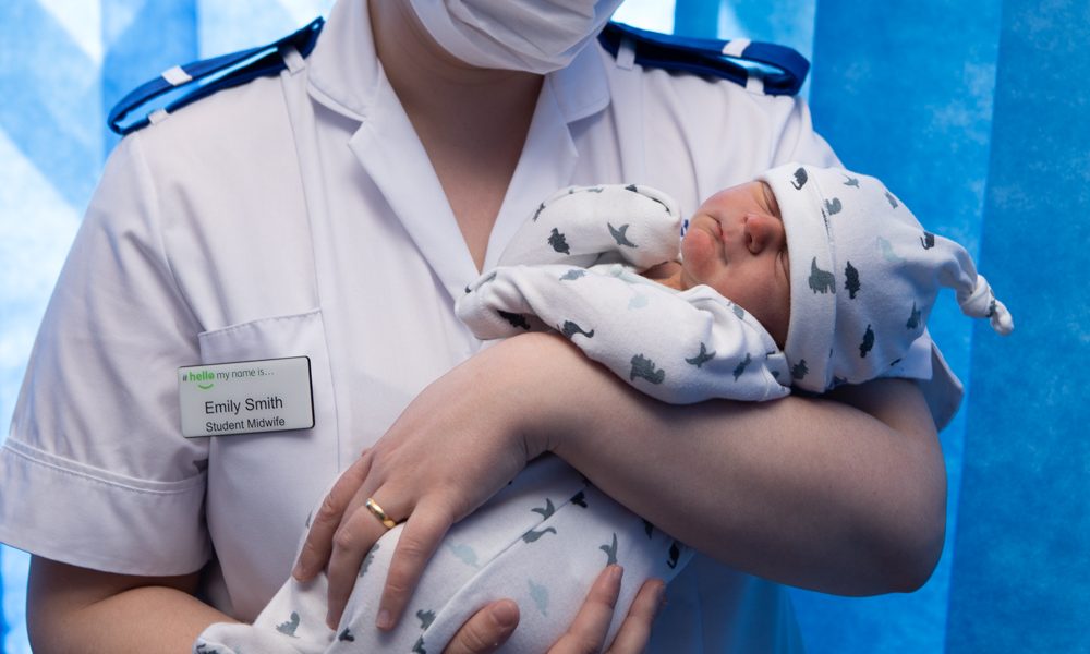 Student midwife Emily Smith holds a newborn at Scunthorpe General