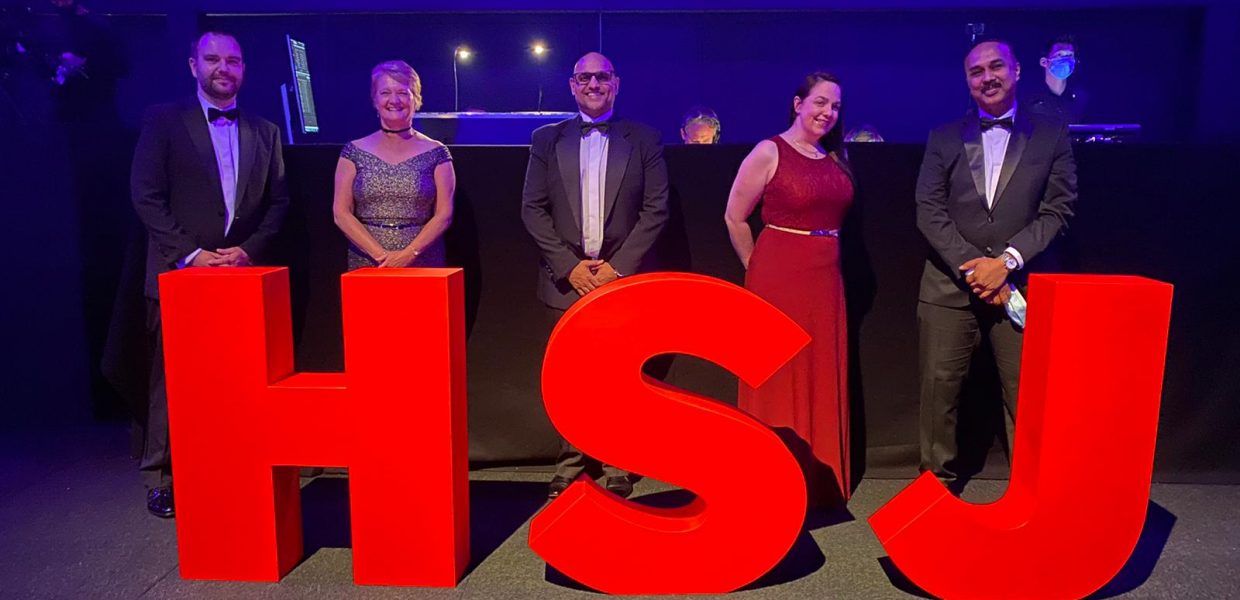 The team picking up their award from the HSJ