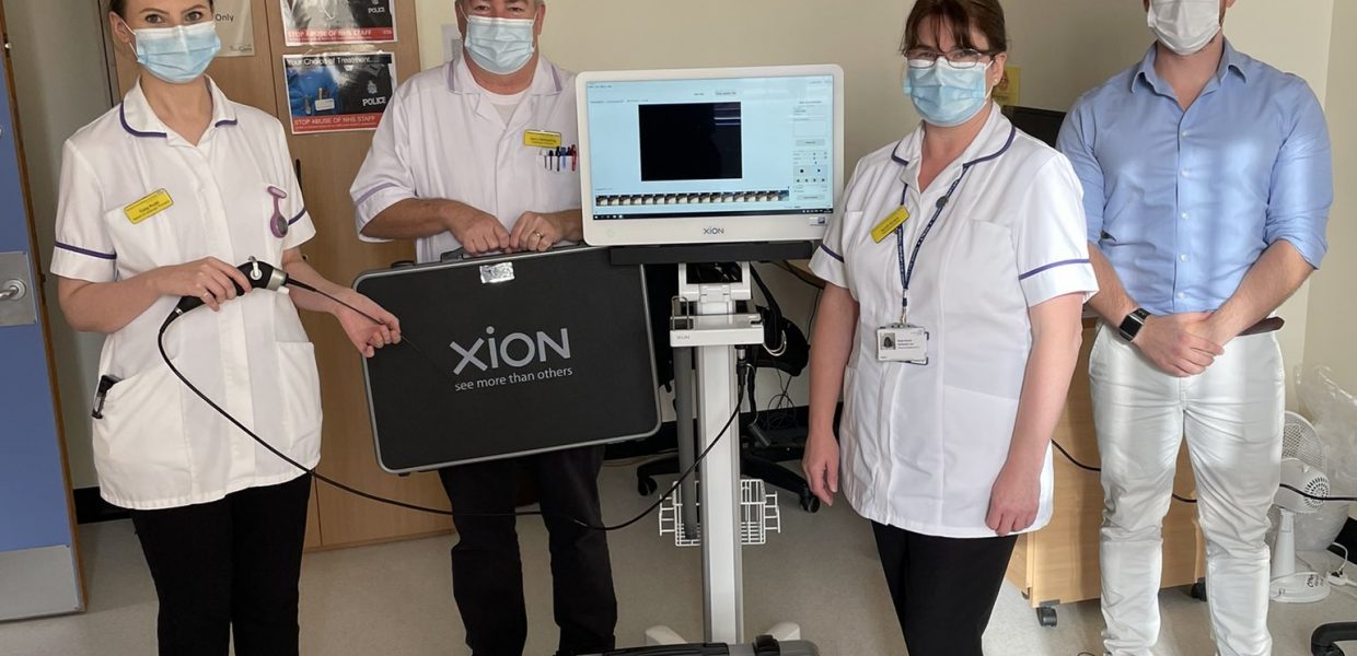 therapy staff stood next to equipment