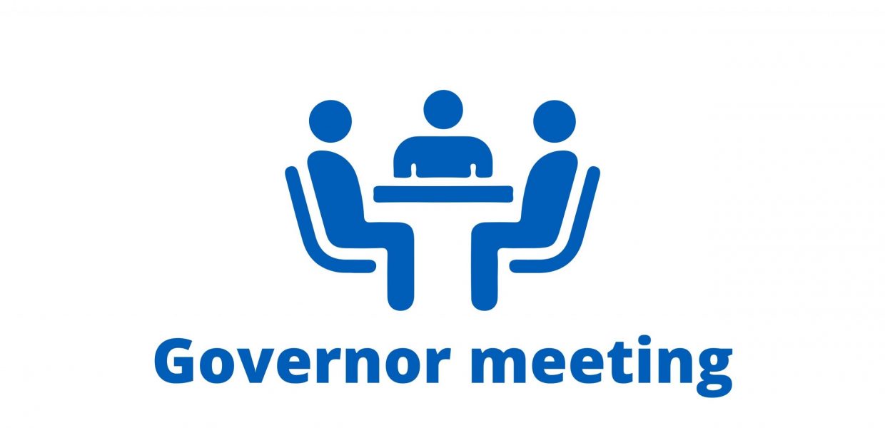 People sat around a table. Blue text on a white background: Governor meeting.