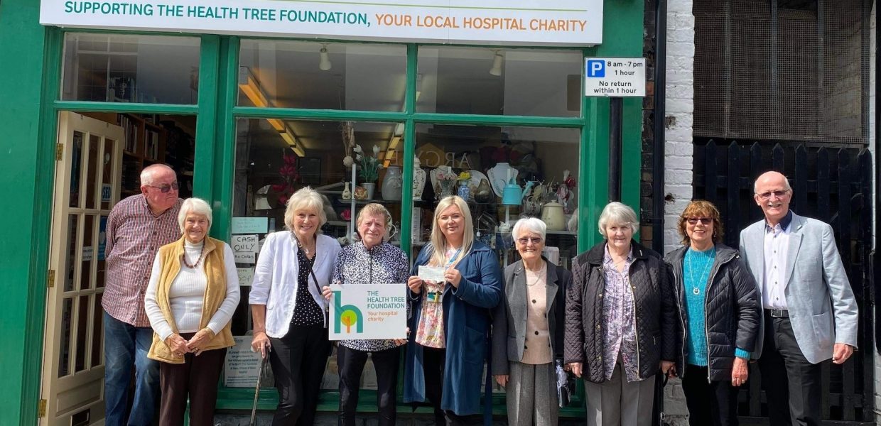 Volunteers and representatives from the Health Tree Foundation stood outside a charity shop