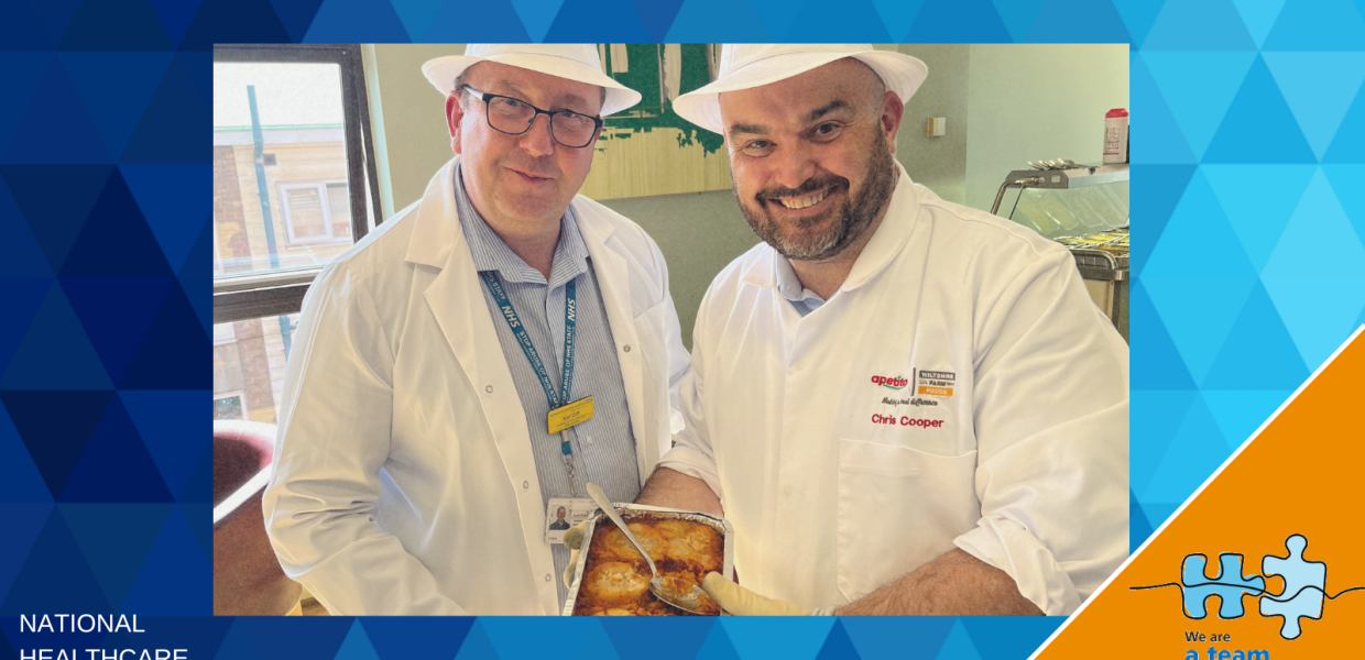 Two members of staff in chef's whites show off one of the new dishes