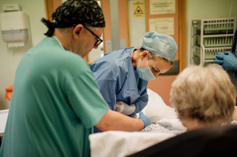 a consultant anaesthetist attends to a patient